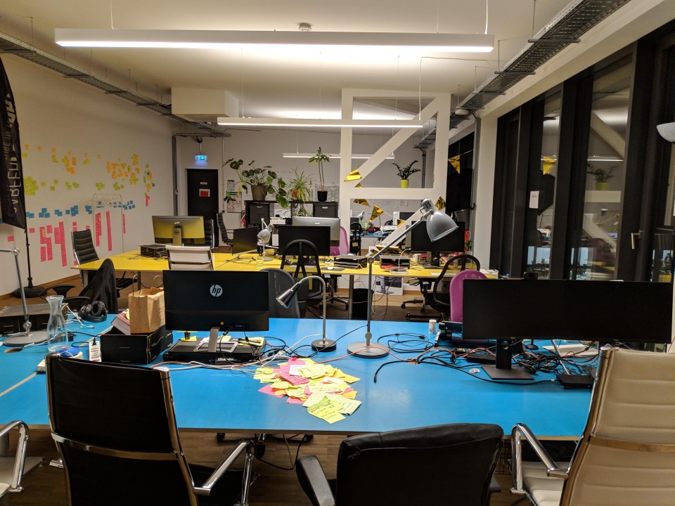 office space at evening time with some desks and postit notes